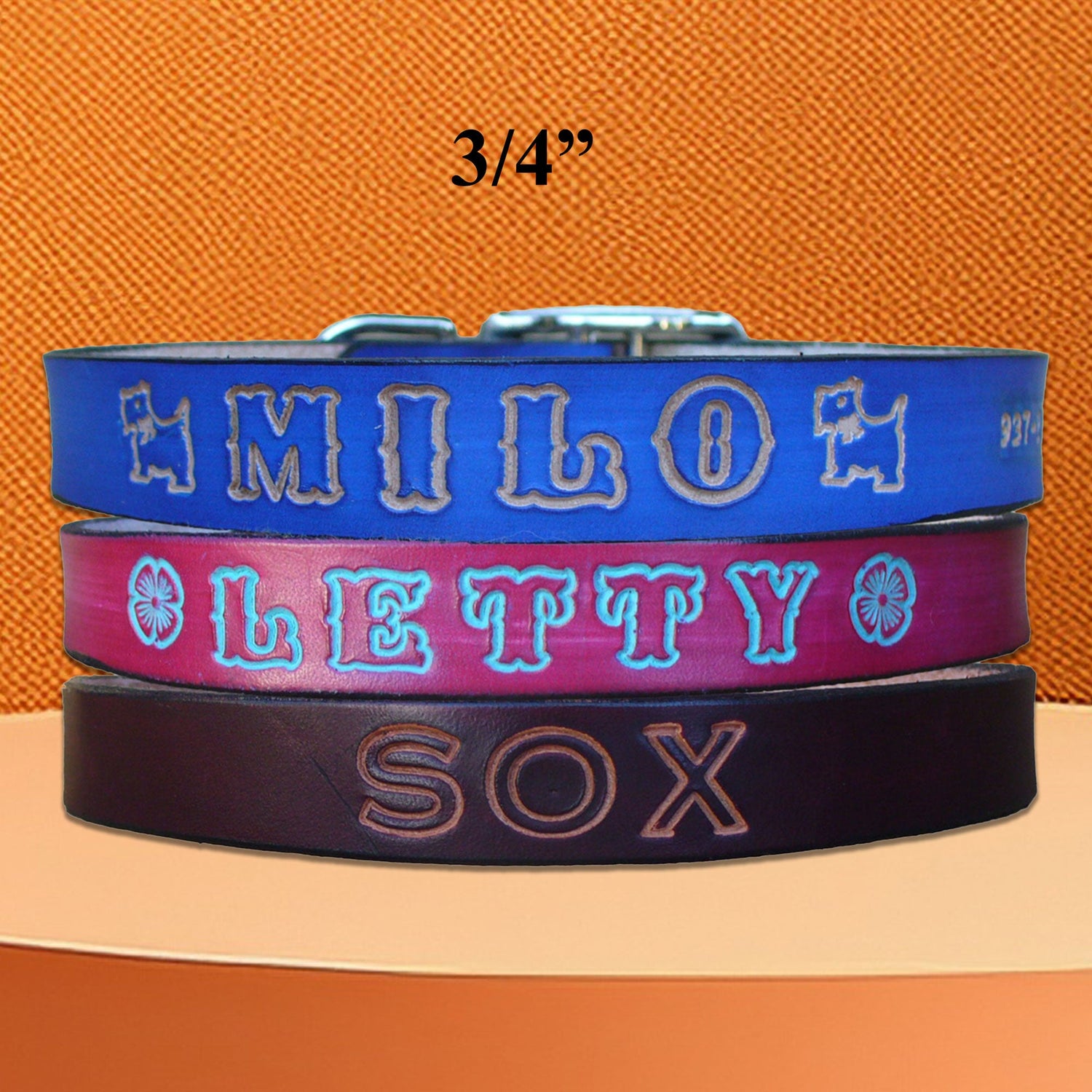 Personalized leather dog collars in various colors, hand-stamped with custom names for medium-sized dogs.