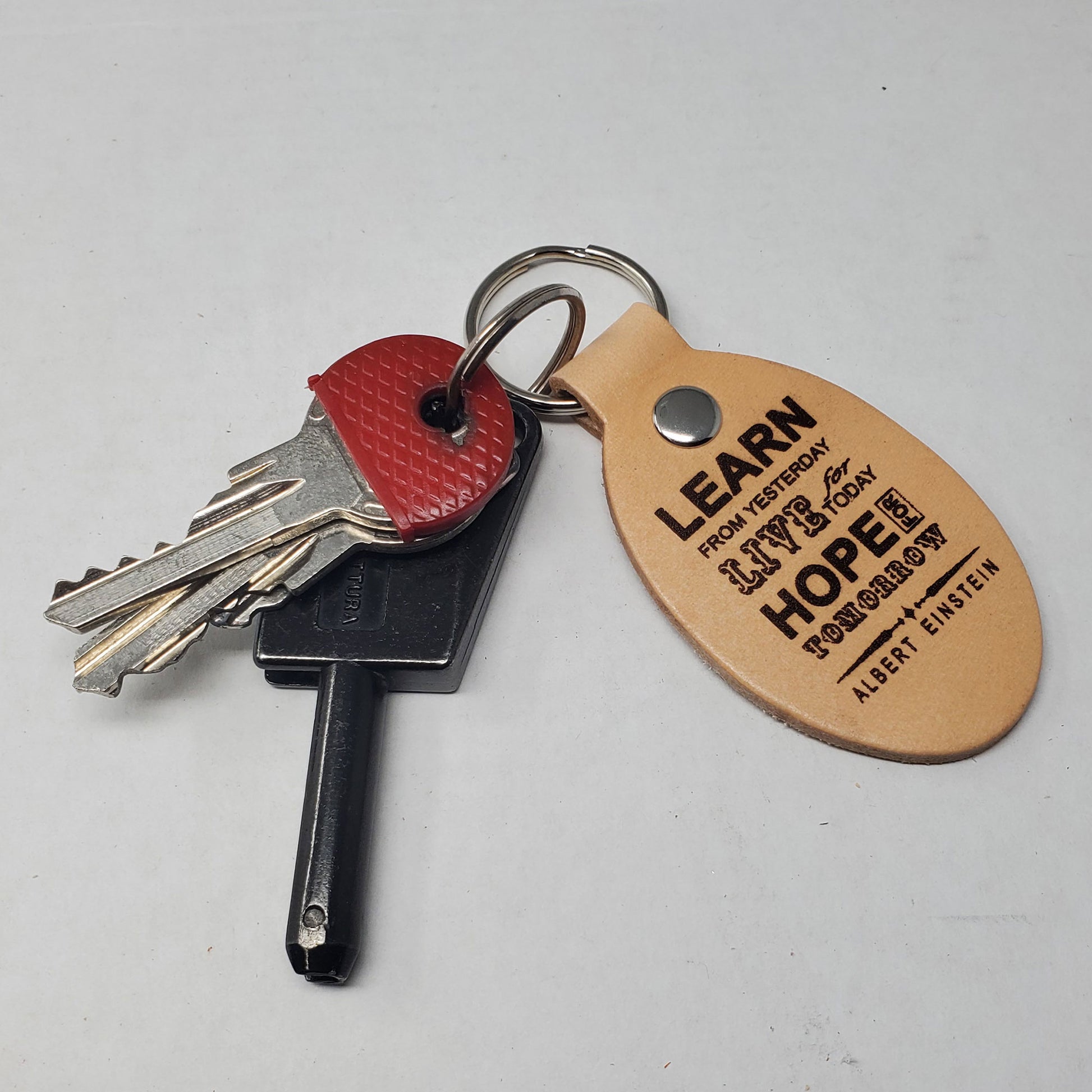 laser engraved leather keyring with albert einstein quote